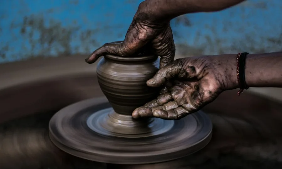 Artisan shaping a ceramic vessel